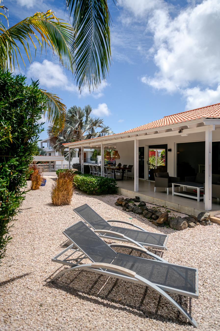 Sun loungers in the side garden next to the veranda
